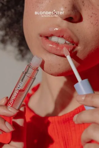 Primo piano di labbra con gloss applicato, campagna Blondesister, make-up